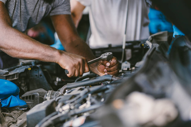 closeup mechanic hand using tool fix service car underhood engine oil replace in auto garace - Фото, изображение
