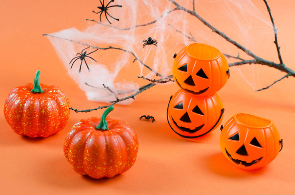 Background for Halloween. Decorations for Halloween on an orange background with place for text. Pumpkins, cobwebs and spiders on an orange background. Halloween party - Zdjęcie, obraz