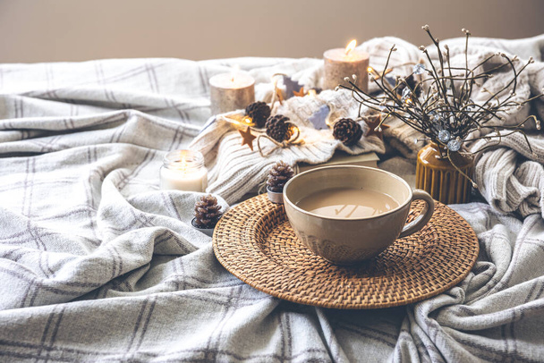 Cozy autumn composition with a large cup of coffee and cute decor details in the bed. - Valokuva, kuva