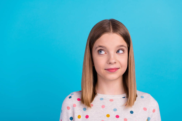 Photo of cute charming little lady dressed dotted pullover smiling looking empty space isolated blue color background. - Φωτογραφία, εικόνα