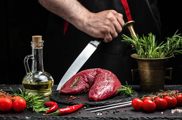 chef hands cooking Tenderloin fillet with rosemary and spices. Preparing fresh beef steak ready to cook, Restaurant menu, dieting, cookbook recipe. place for text. - Fotoğraf, Görsel