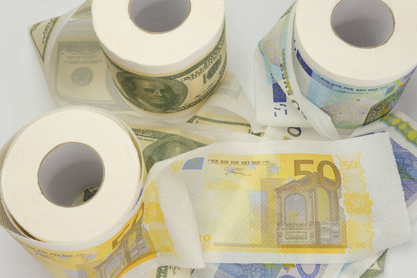 Rolls of bank notes toilet paper on white background - Φωτογραφία, εικόνα