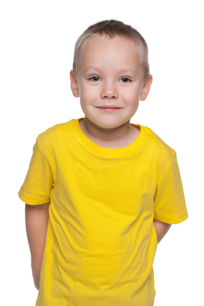 Blond little boy in a yellow shirt - Фото, изображение