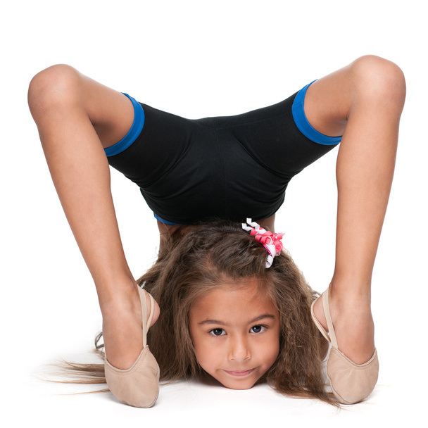 Little gymnast does exercises - Foto, Imagen