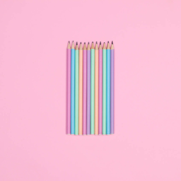 Colorful pastel wooden pencils on pastel pink background. Flat lay - Fotografie, Obrázek