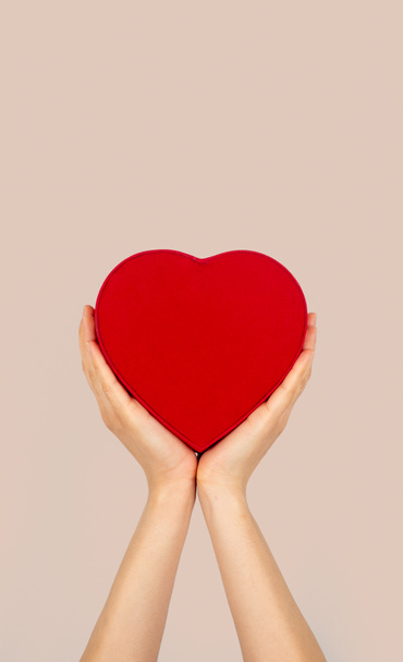 Hands holding heart shaped box with isolated background. charity and donation concept. - Foto, Imagem