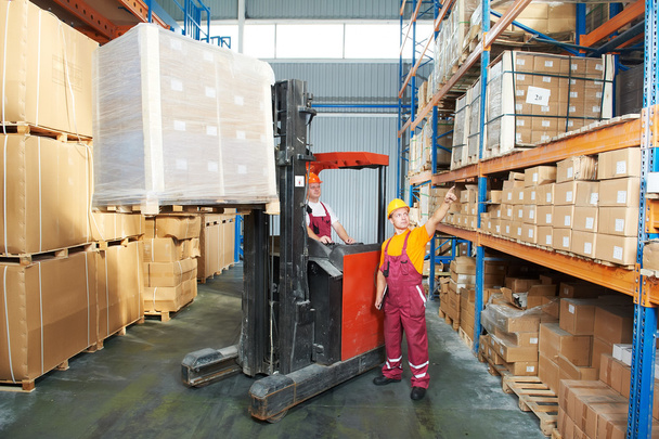 Distribution in warehouse with forklift - Fotoğraf, Görsel