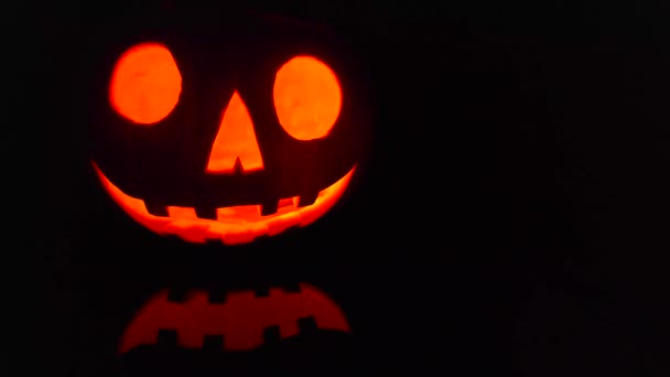 Close-up on a Jack O Lantern glowing in the dark - Felvétel, videó