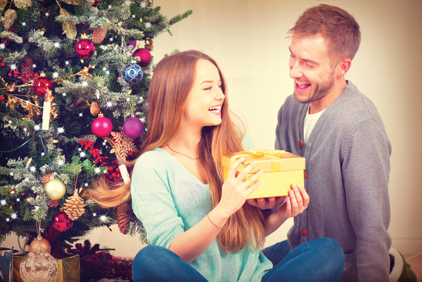Couple with Christmas Gift at Home. - Fotó, kép