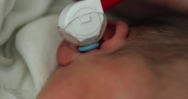 Newborn physical ear examination, doctor examining infant baby - Materiaali, video