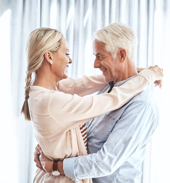 Living in the moment. an affectionate mature couple dancing in their home - Photo, image
