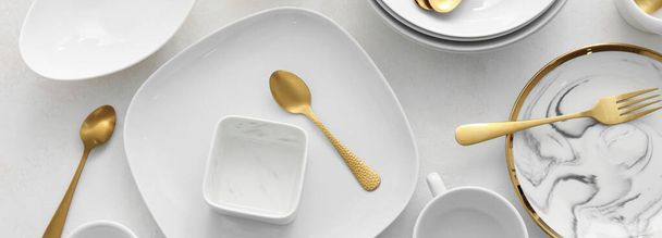 Set of clean dinnerware and cutlery on white background, top view - Foto, Imagen