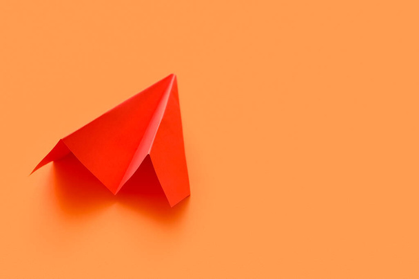 Red paper plane on orange background - Фото, изображение