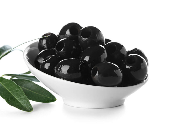 Bowl of tasty black olives on white background - Photo, image