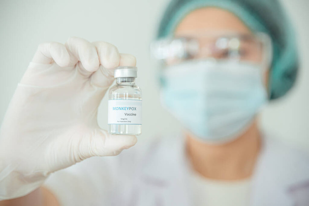 Врач или ученый держит пузырек с вакциной от оспы или клады. - Фото, изображение