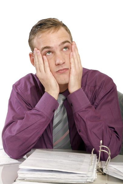 Exhausted man in office with documents - Photo, image