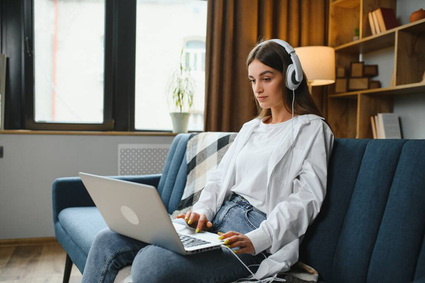 Full length portrait of cheerful charming person sit hold netbook browsing have good mood working home indoors. - Фото, зображення