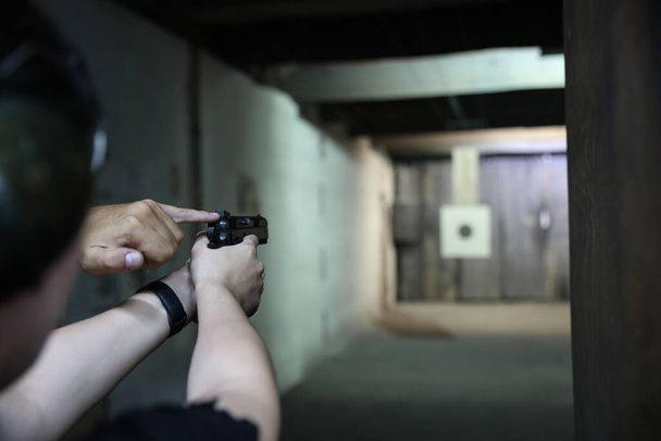 Woman Pistol bullseye target training in a shooting club - Fotó, kép