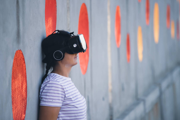 Woman wearing virtual reality goggles. Metaverse, technology, video game, futuristic concept - 写真・画像