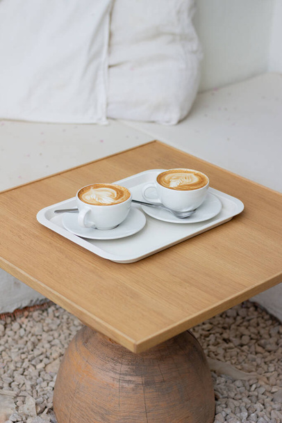 cup of coffee on wooden table - Fotoğraf, Görsel