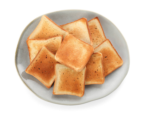 Plate with slices of delicious toasted bread on white background, top view - Foto, Imagem