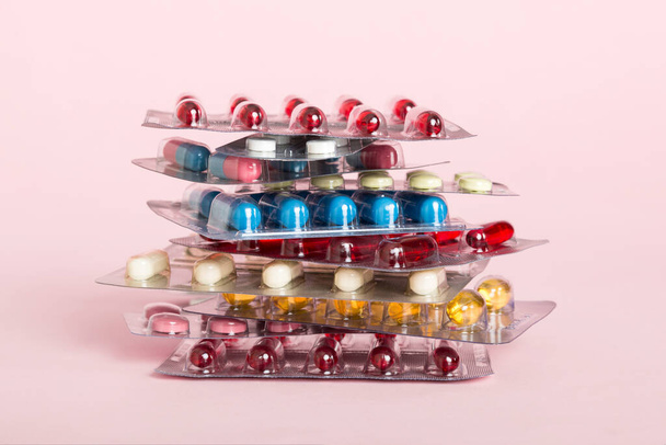 too many different pill cartridges stacked. selective Focus. Packs of blister pills with tablets. Colored pastilles packages. A pile of medicine in blister packs. Pharmaceutical blister packs. - Photo, Image
