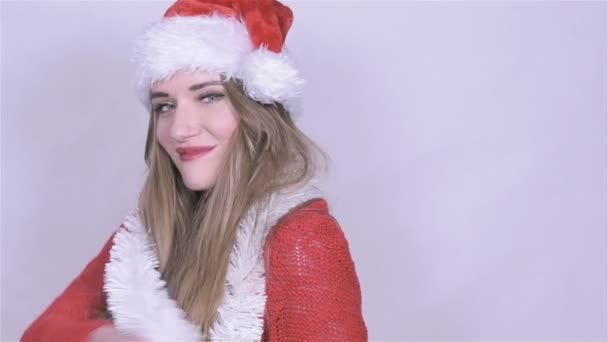Beautiful woman with white chain on her neck and christmas hat posing in studio. - Materiaali, video