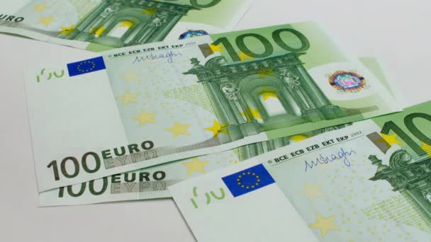 Recalculation of money. EU euro banknotes are falling on a white background. One hundred euro banknotes pack. Euro banknotes close-up. EU currency. Money is falling. High quality 4k footage - Video