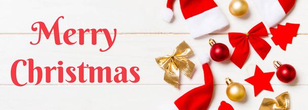 Merry Christmas text. Banner top view of Christmas decorations and toys on wooden background. Copy space. Empty place for your design. New Year concept. - 写真・画像