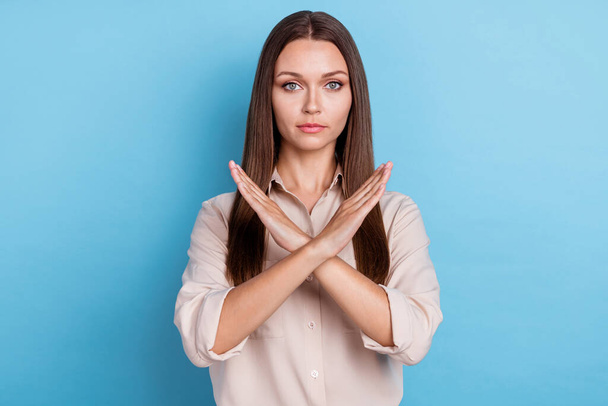 Photo of charming serious young woman arms crossed show stop symbol dressed trendy smart casual clothes isolated on blue color background. - Fotó, kép
