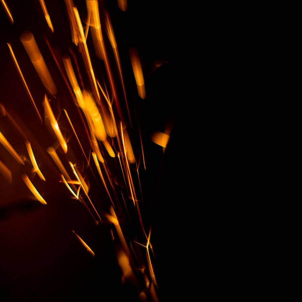abstract image of sparks from a circular saw, photographed in close-up macro mode. Front and back background blurred with bokeh effect - Zdjęcie, obraz