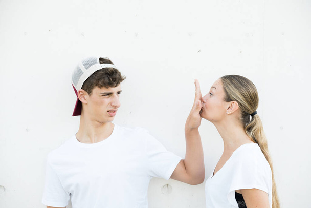 Displeased teenager boy rejecting kiss from girl with halitosis. - Valokuva, kuva