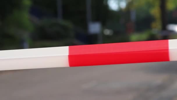 Red white barrier tape in pandemic lockdown marks crime scene restricted area as margin of safety to prohibit no trespassing in dangerous emergency and protection boundary for quarantine security stop - Filmmaterial, Video