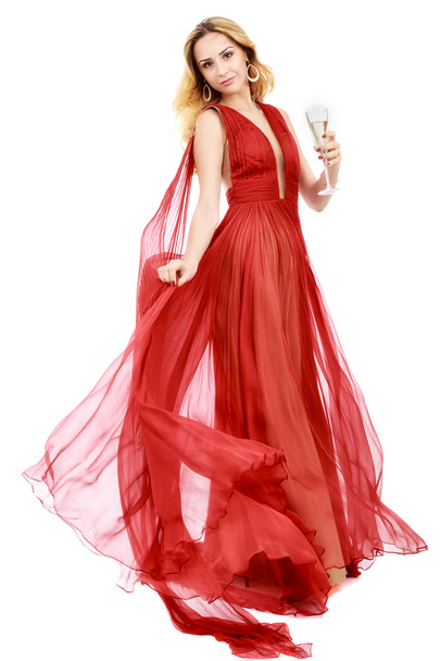 όμορφη κομψή γυναίκα με κόκκινο φόρεμα με ένα ποτήρι σαμπάνια c - Φωτογραφία, εικόνα