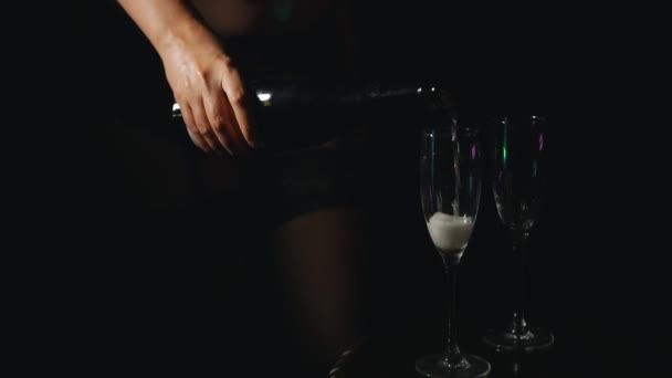 Woman pouring champagne in glasses in strip club. - Filmati, video