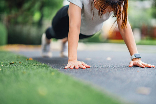 Fitness training outdoor, Healthy lifestyle concept Closeup - Sport woman doing push ups in the park. - Fotó, kép