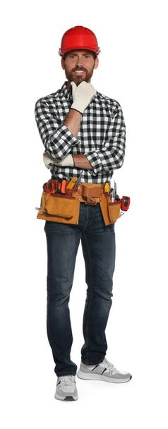 Professional builder in hard hat with tool belt isolated on white - Foto, afbeelding