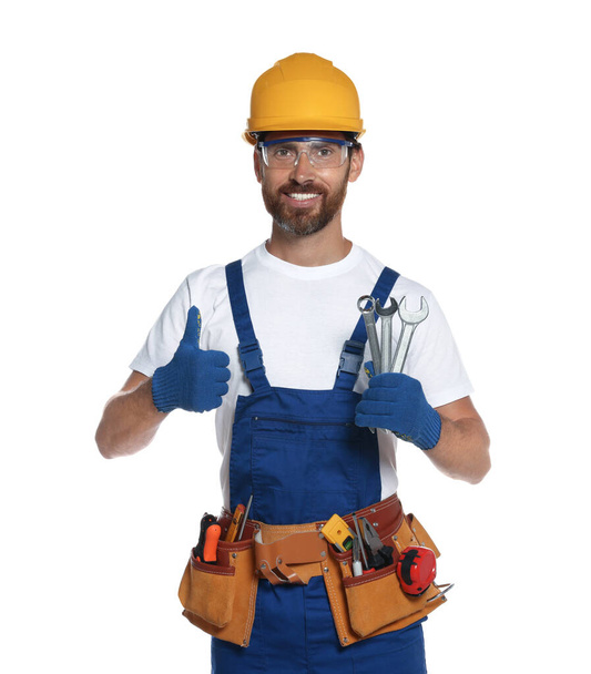 Professional builder in uniform with tool belt isolated on white - Фото, изображение