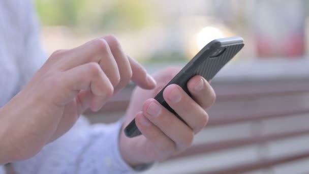Male Hand Browsing Internet on Smartphone Outdoor - Felvétel, videó