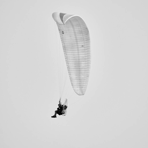 Italy; Sicily, man flying on a powered paraglider  - Photo, image