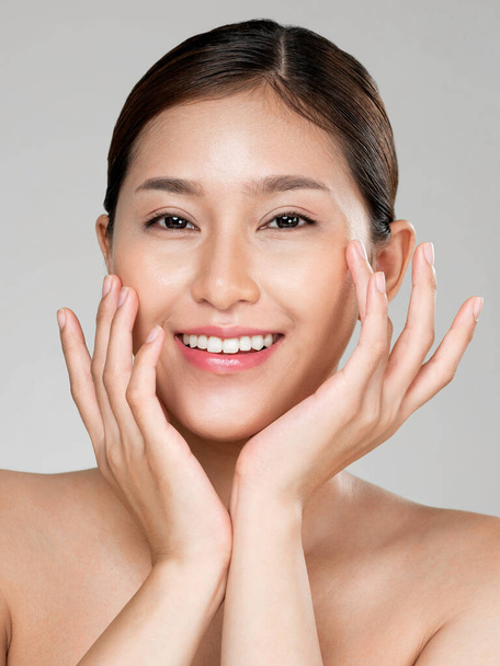 Closeup ardent young woman with healthy clear skin and soft makeup looking at camera and posing beauty gesture. Cosmetology skincare and beauty concept. - Photo, image