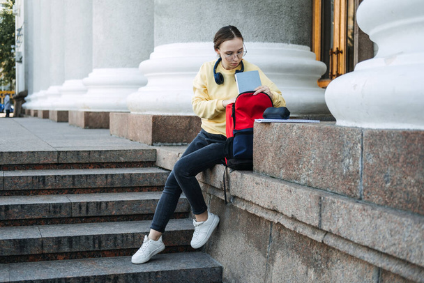 Choose university and right degree. How to Choose College or University. Happy student girl with laptop and books near the university or college building - Foto, immagini