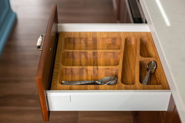 Modern kitchen. Set of cutlery trays in kitchen drawer. Solid oak wood cutlery drawer inserts. - Foto, Imagen
