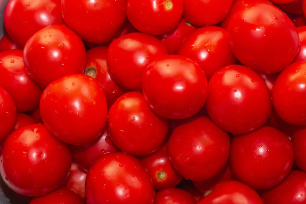 Red ripe tomatoes as background, closeup. Food backgrounds concept - Foto, Imagem