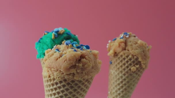 Turquoise blue and caramel ice cream on a pink background. High quality 4k footage - Materiał filmowy, wideo