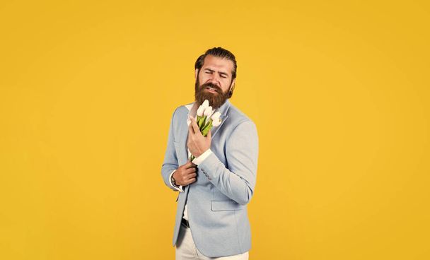 spring present. true gentleman with bouquet. love date concept. bearded man in formalwear with tulip flowers. elegant businessman wear elegant apparel for formal event. - Foto, imagen
