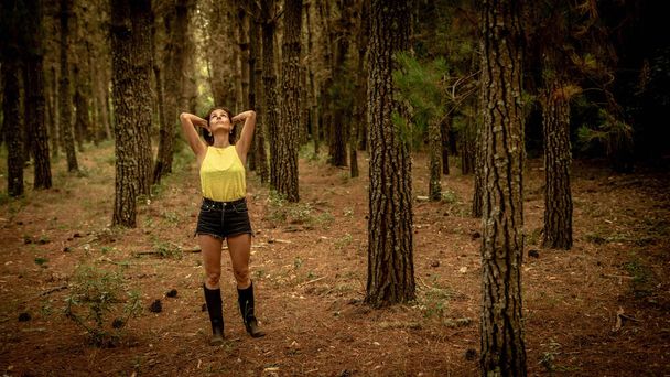 woman in the forest with open arms absorbs the energy of nature - Fotó, kép