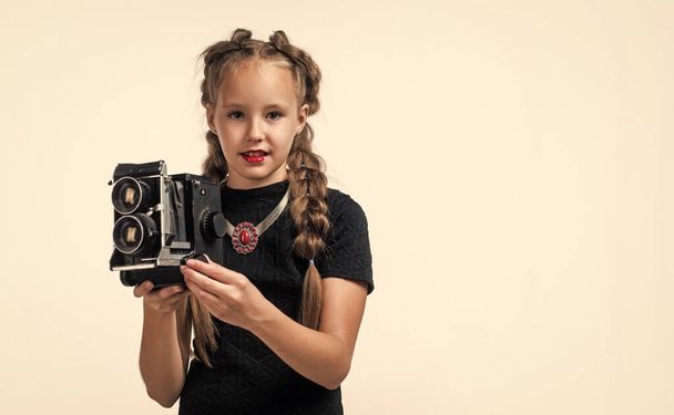 perfect photography of child. happy childhood. beauty and fashion. cheerful kid with vintage camera isolated on white. retro teen girl with braided hair making photo. photographing. - Photo, Image