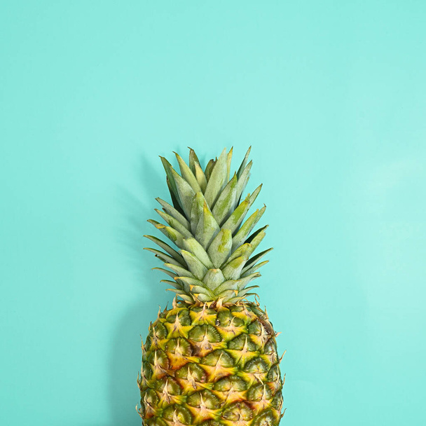 Fresh ripe pineapple on pastel blue background. Flat lay summer concept. Minimal - Фото, изображение