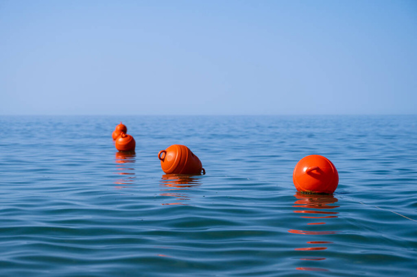 Orange floating buoys in the sea. Human life saving concept. Blue sky. - Fotoğraf, Görsel